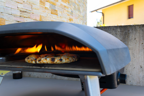 fresh pizza ready to come out of the ooni pizza oven